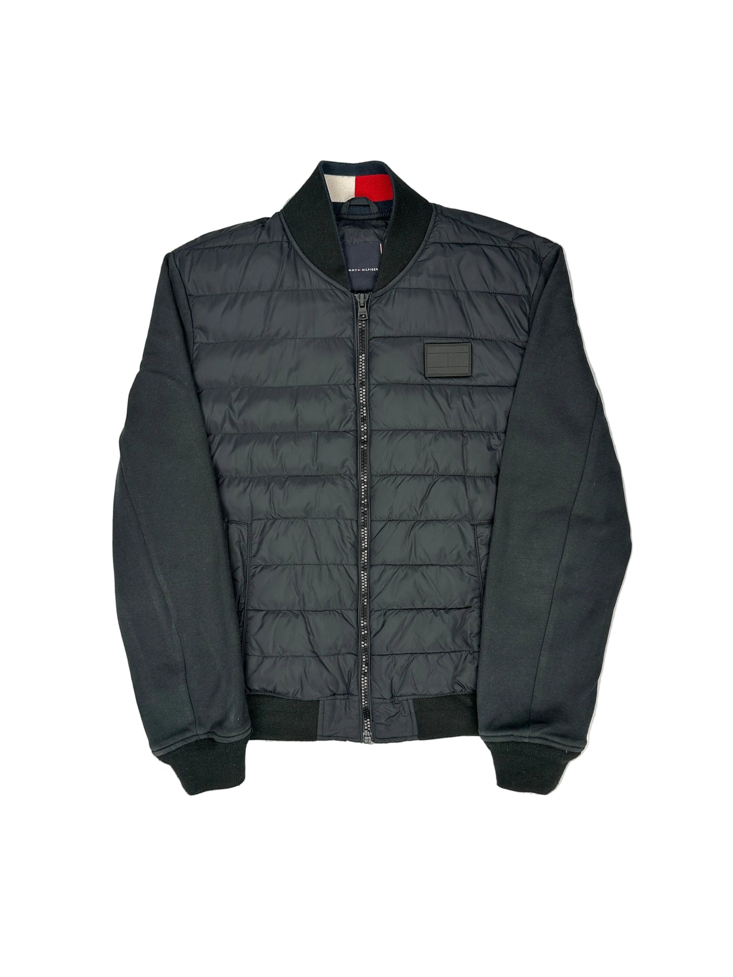 Black quilted jacket on a white mannequin against a gray background Black quilted jacket on a white mannequin against a gray background