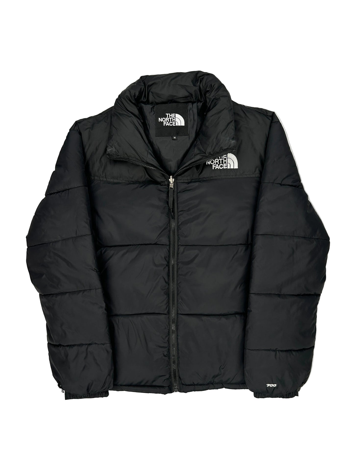 Black puffer jacket with The North Face logo on a light gray background Black puffer jacket with The North Face logo on a light gray background