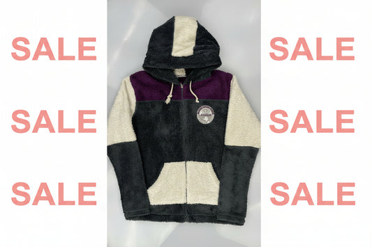 Folded fleece jacket with black, purple, and white colors on a light gray background