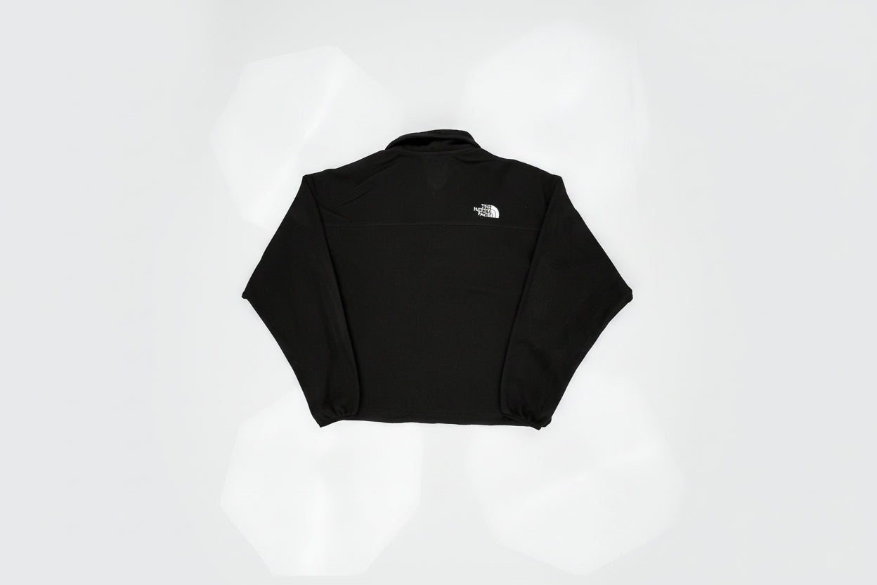 Black sleeveless top with a small logo on a white background