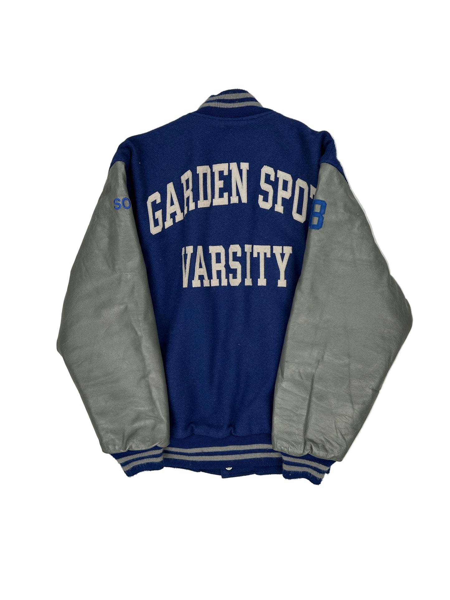 Folded blue and gray varsity jacket with 'Garden Sport Varsity' text on a white background