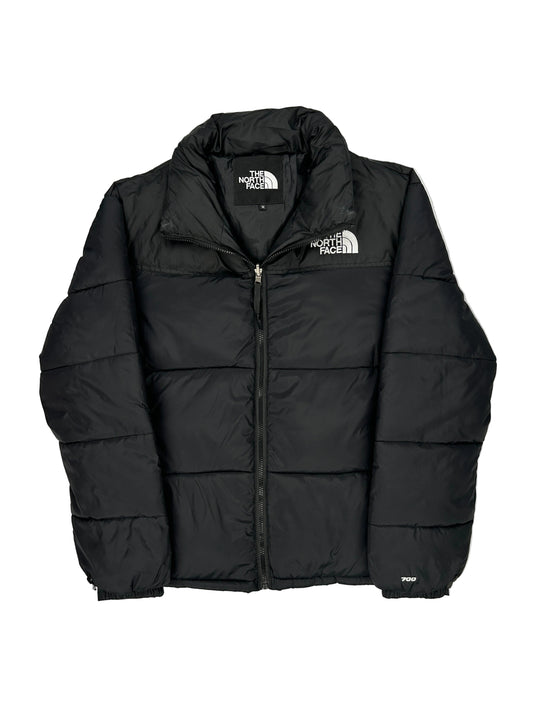 Black puffer jacket with The North Face logo on a light gray background