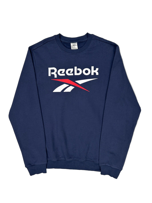 Folded navy blue Reebok shirt on a white background