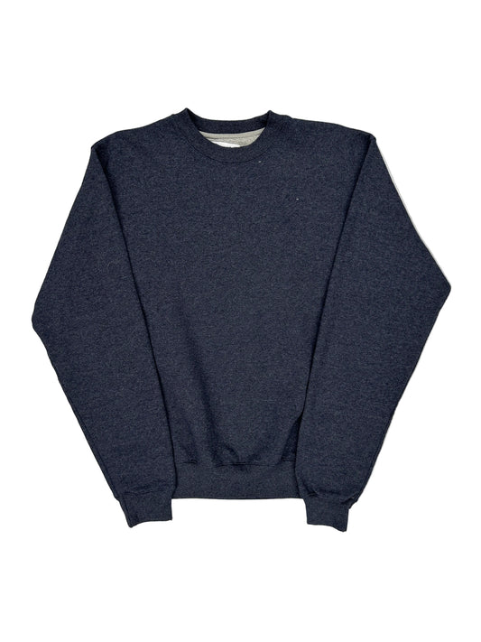 Folded navy blue shirt on a light gray background