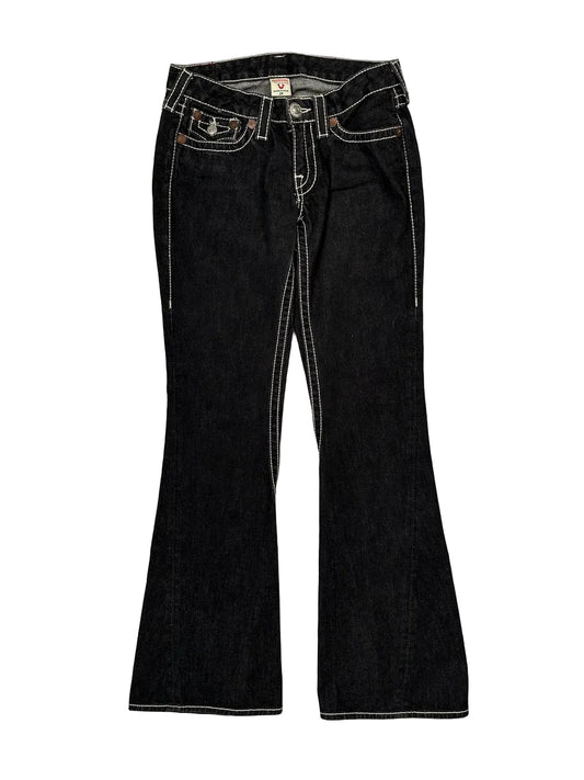 Black flared jeans on a light gray background